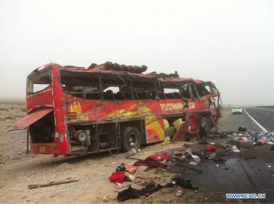 Photo taken on Feb. 25, 2015 shows the scene of a road accident site in Bachu County, Kashgar Prefecture, northwest China's Xinjiang Uygur Autonomous Region. A long-distance bus overturned on an expressway which links Kashgar with Aksu, late Tuesday night, killing 22 people and injuring 38 others. (Xinhua) 134017893_14249078168821n