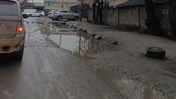 На улице Салиевой яма на проезжей части и лужи