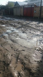Жители ул.Орозова жилмассива Кызыл-Аскер вынуждены ходить в бахилах из-за плохого состояния дороги, - читатель (фото)